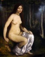 Young woman seated in a forest
