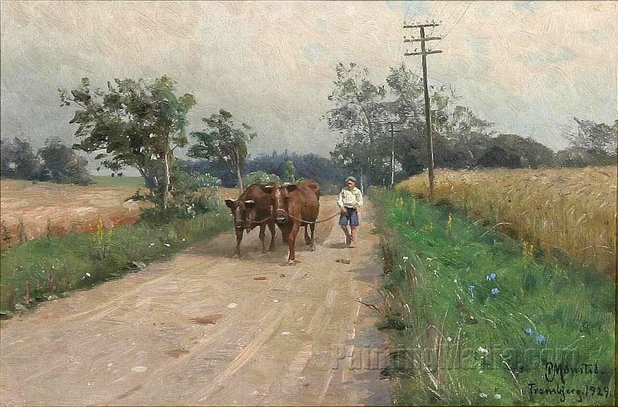 A boy leading cows along a road